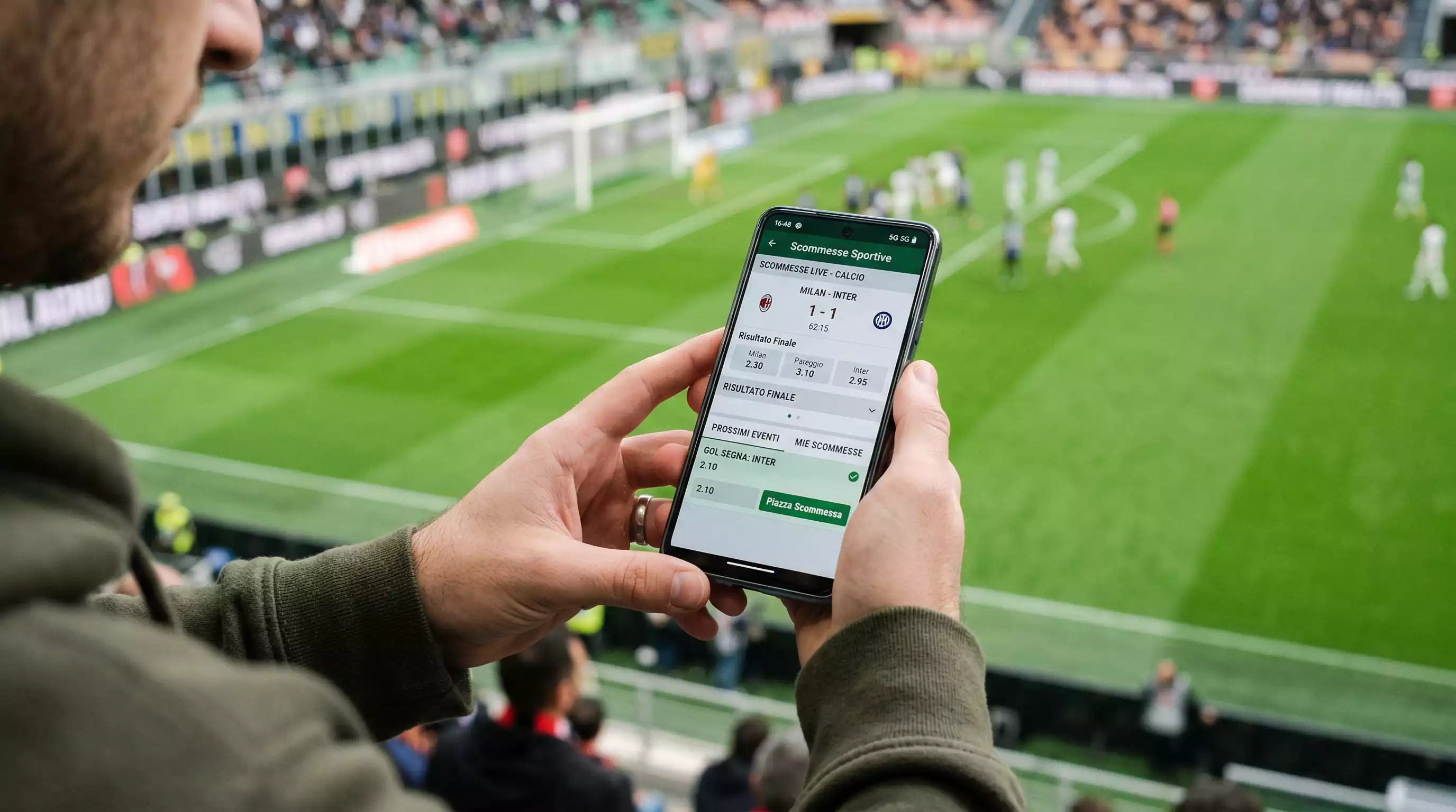 Smartphone con interfaccia di scommesse sportive su campo da calcio